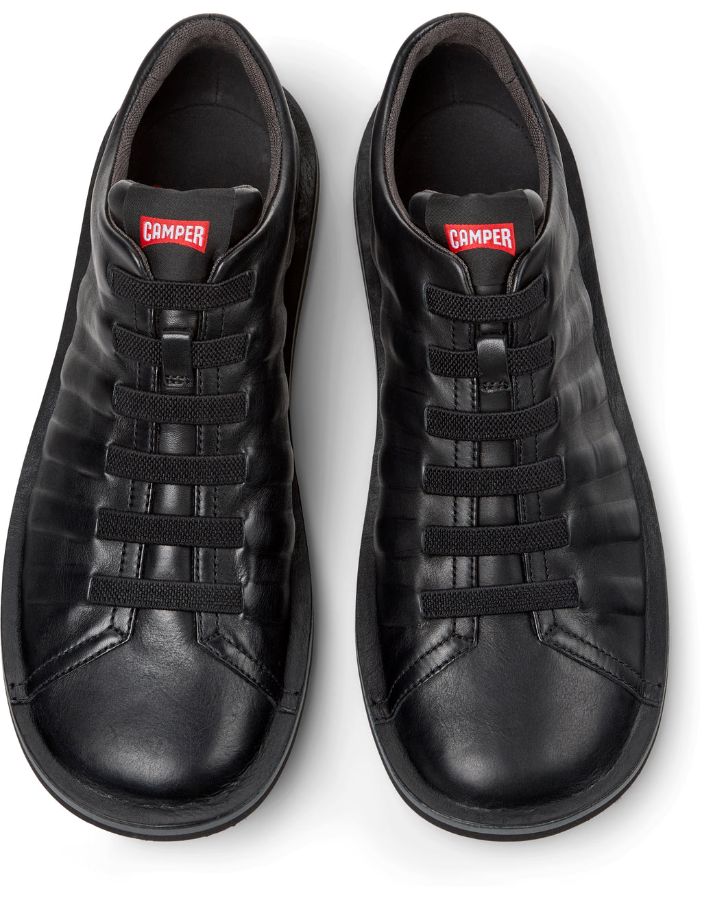Pair of black sneakers with a visible brand logo on a white background