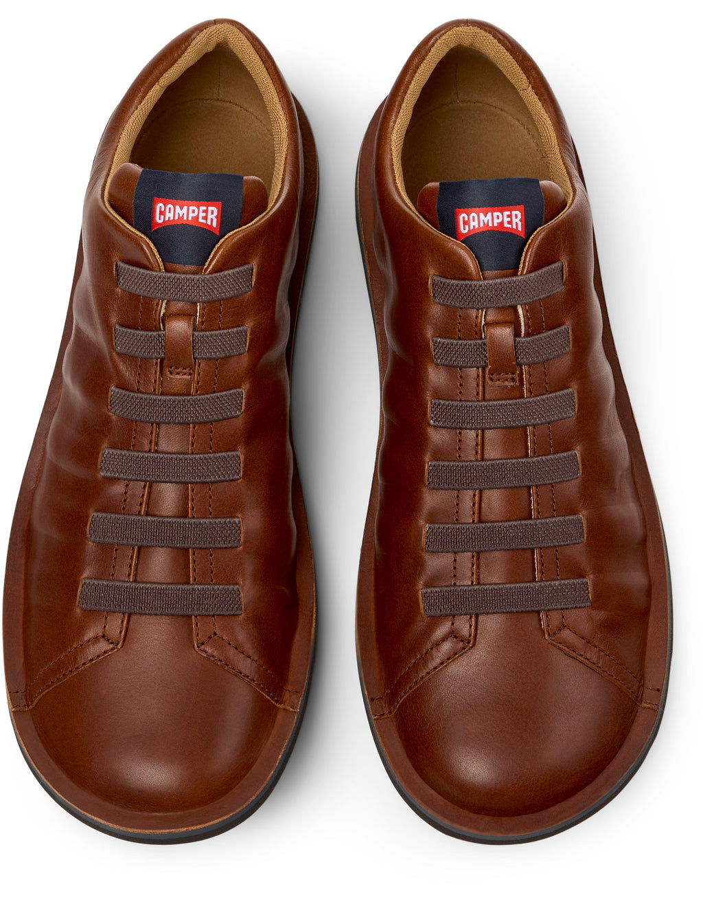 Pair of brown leather shoes with laces on a white background, featuring the Camper brand.