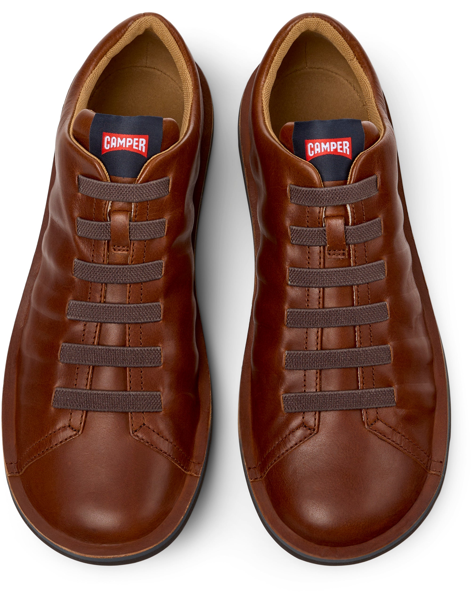 Pair of brown leather shoes with laces on a white background, featuring the Camper brand.