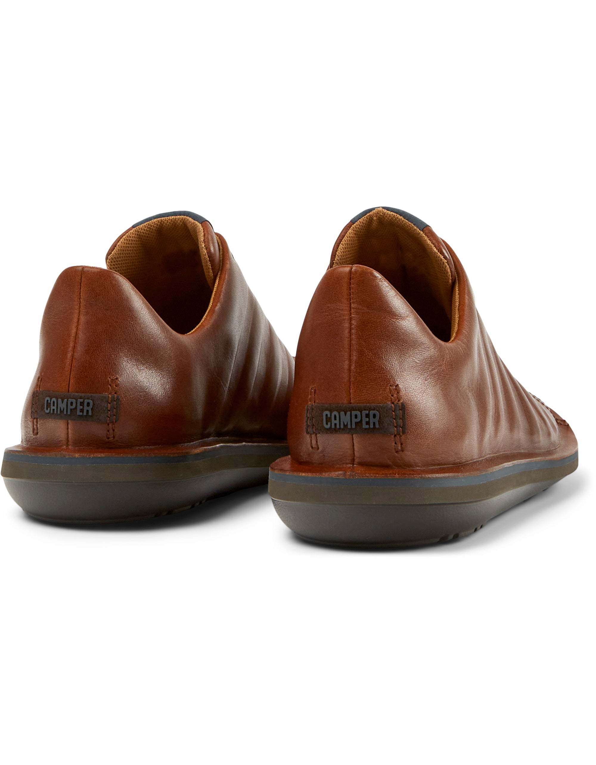 Pair of brown leather shoes with 'Camper' branding on a white background