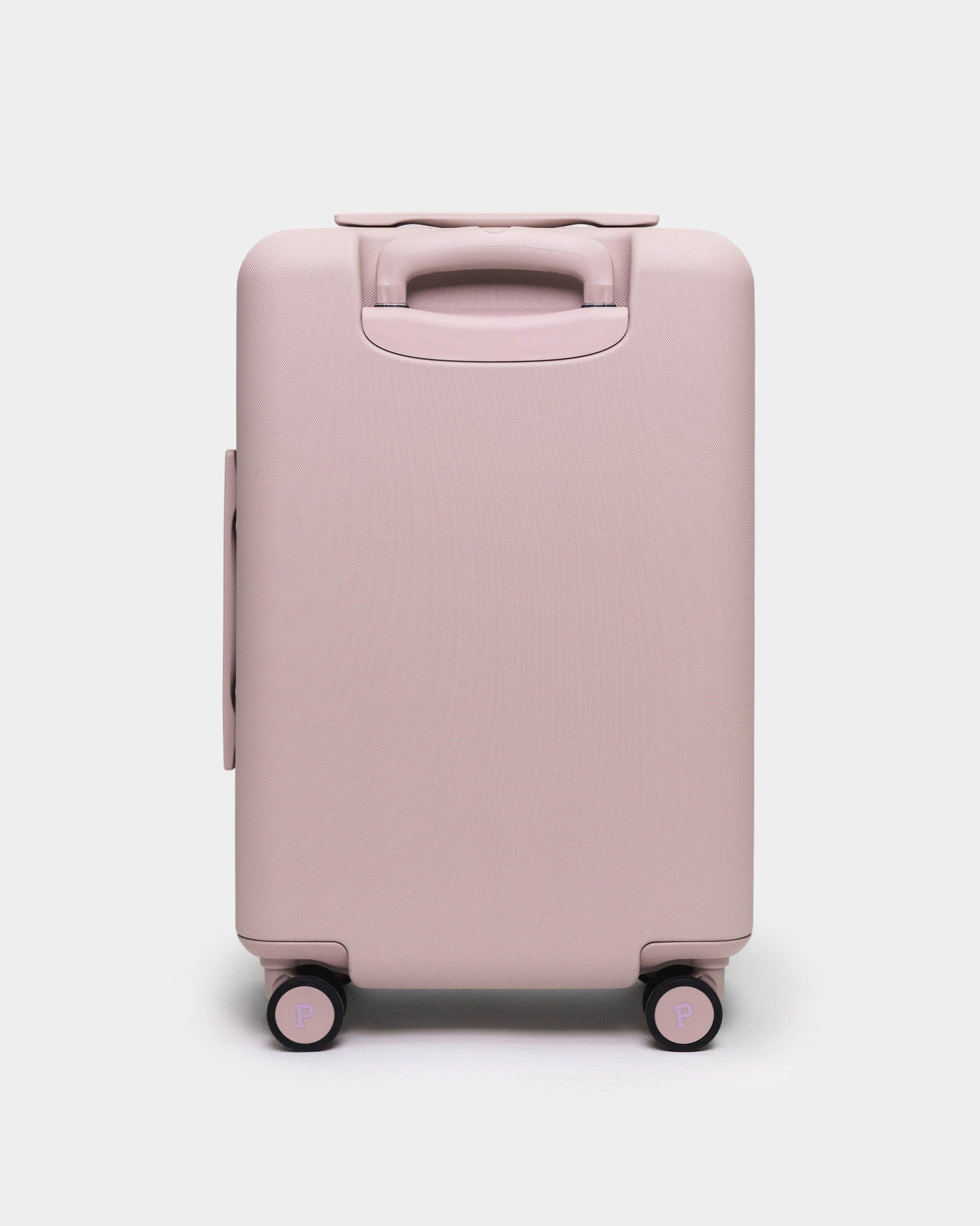 Pink suitcase on a white background