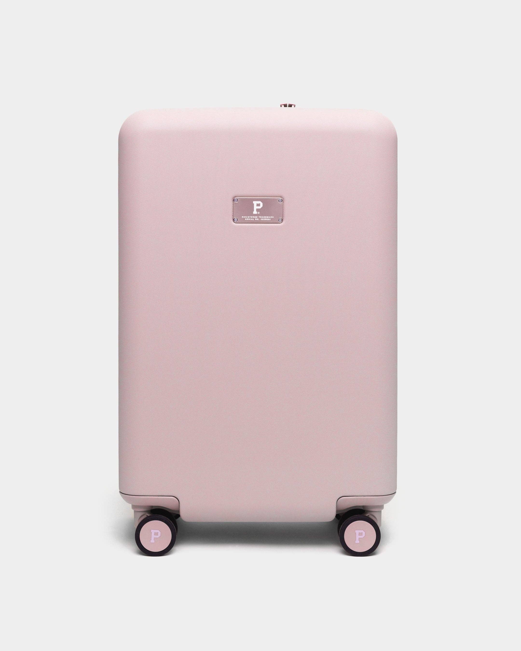 Pink suitcase with a visible brand logo on a white background