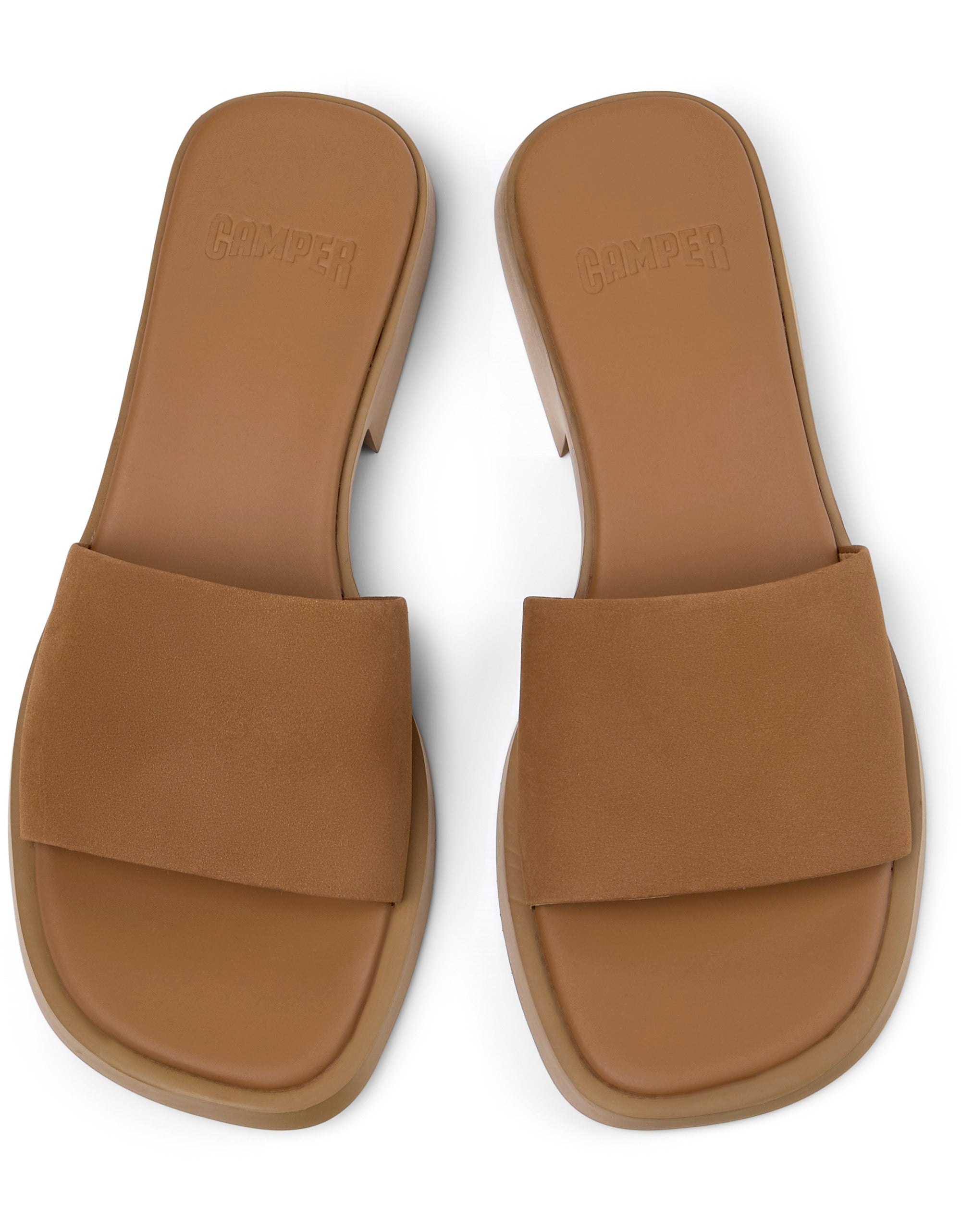 Pair of tan sandals on a white background