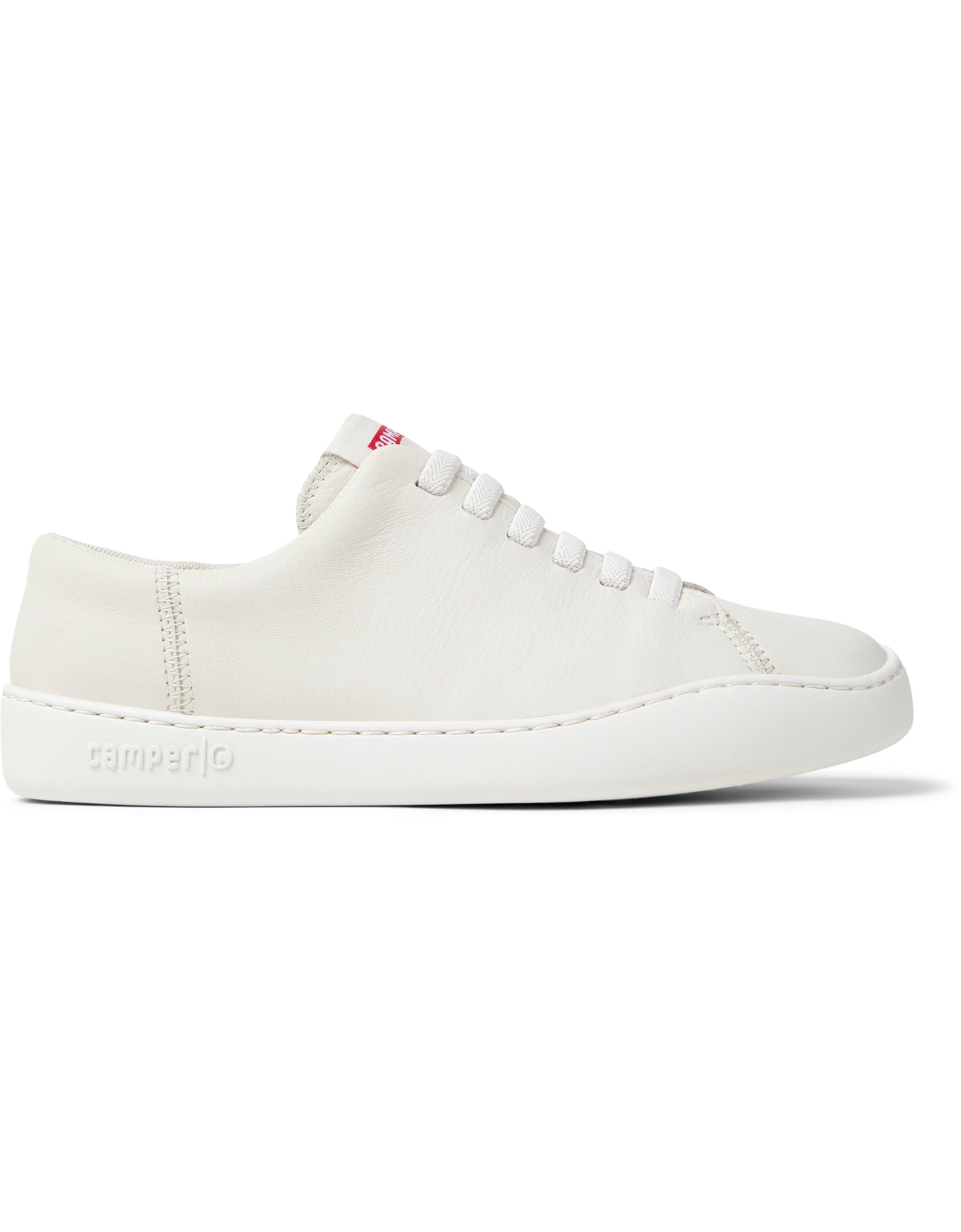 White sneaker with a visible brand logo on a white background