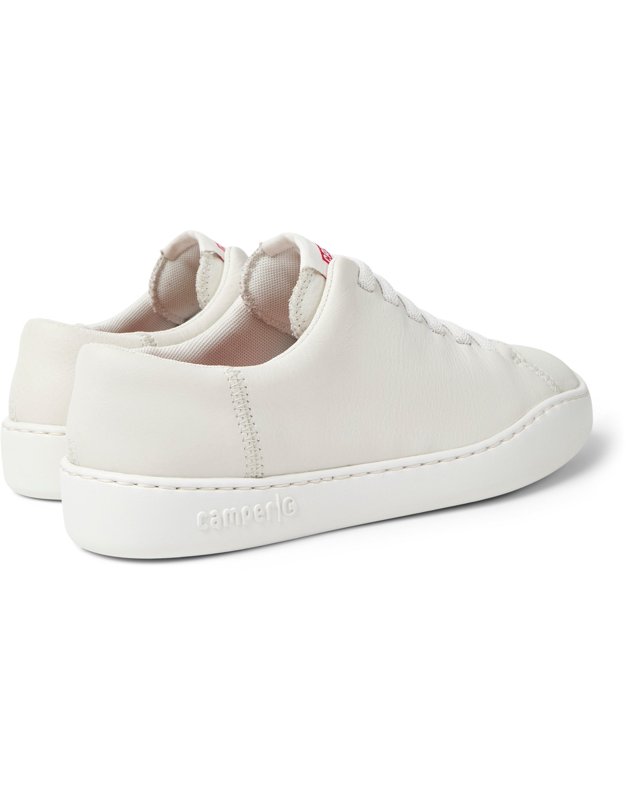 White sneakers with a visible brand logo on a white background