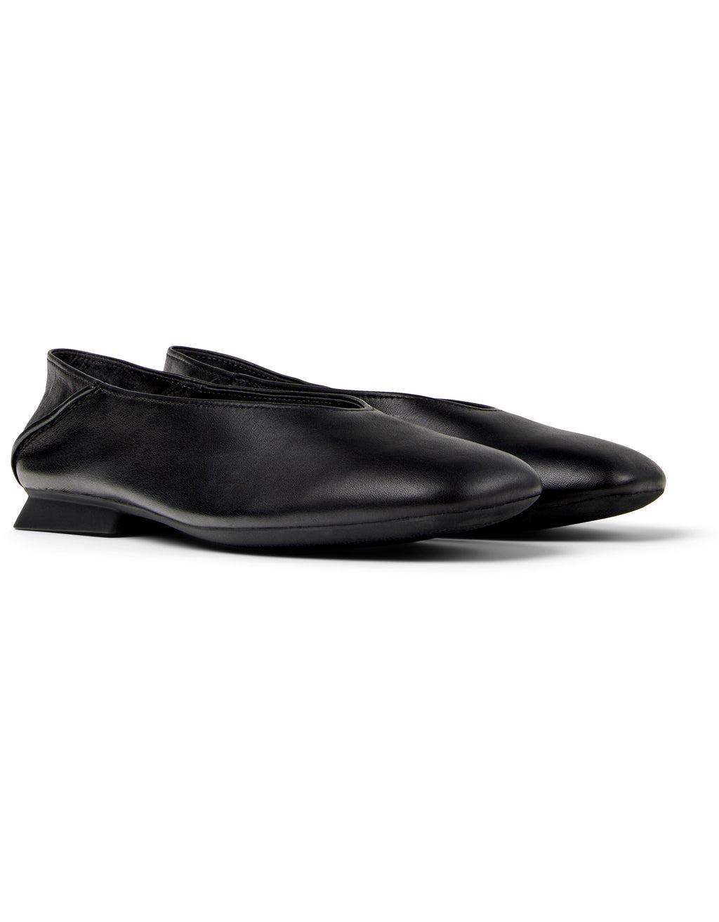 Pair of black ballet flats on white background