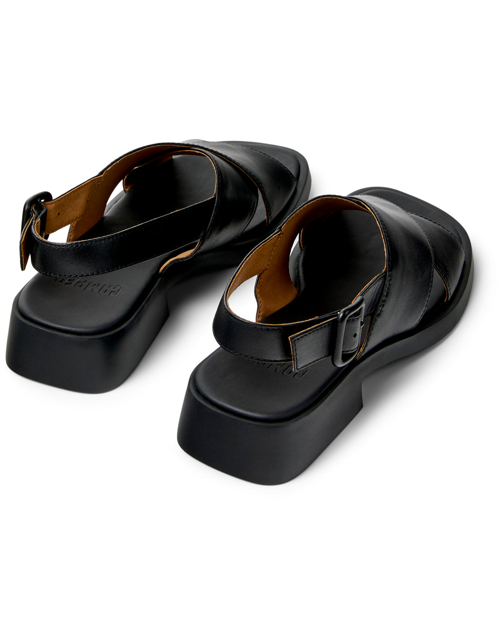 Pair of black sandals with buckles on a white background