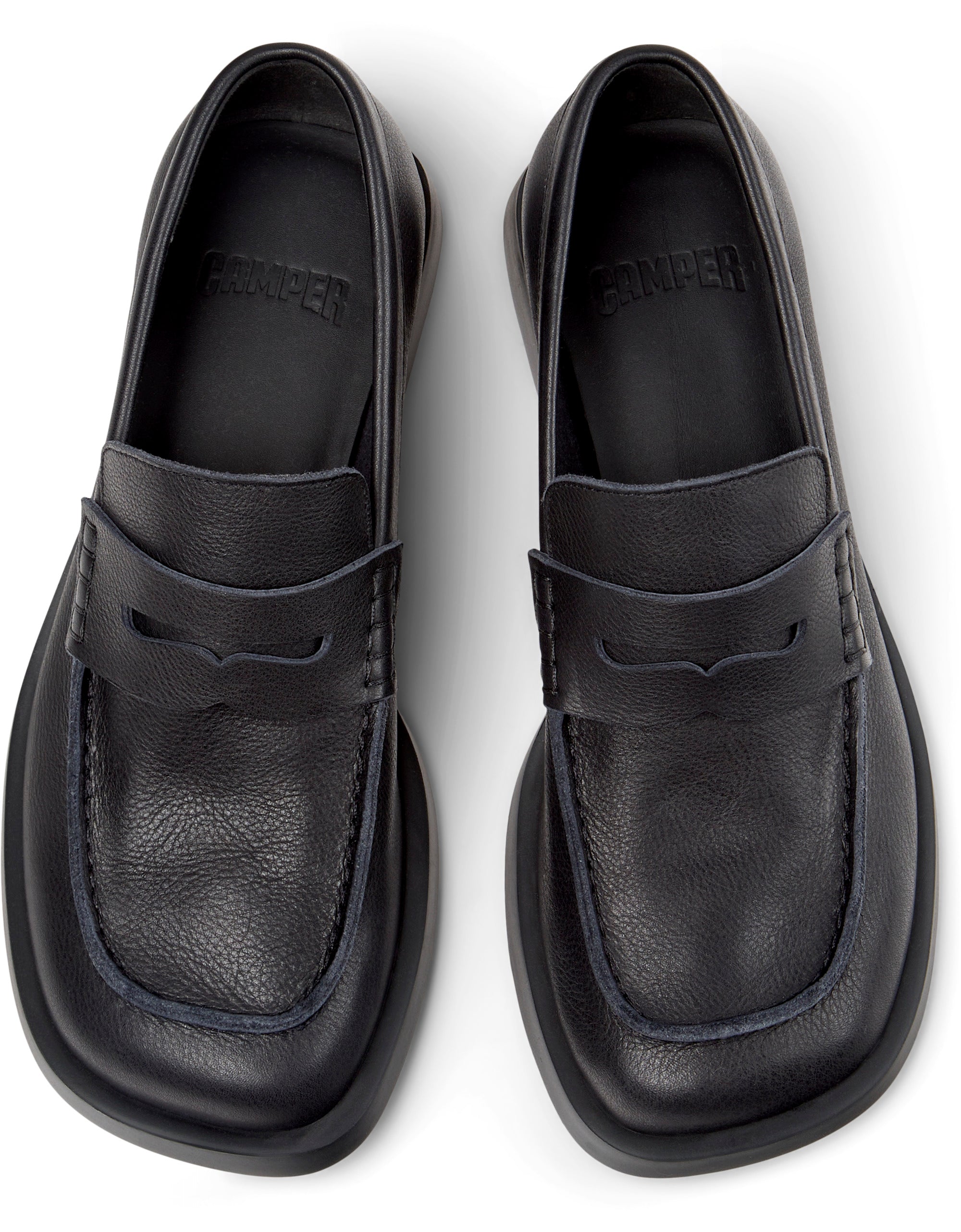Black loafers on a white background