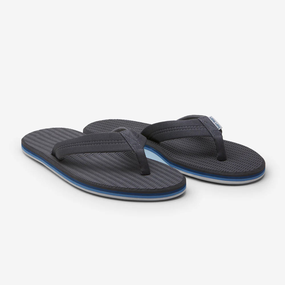 Pair of dark charcoal flip-flops with blue soles on a white background