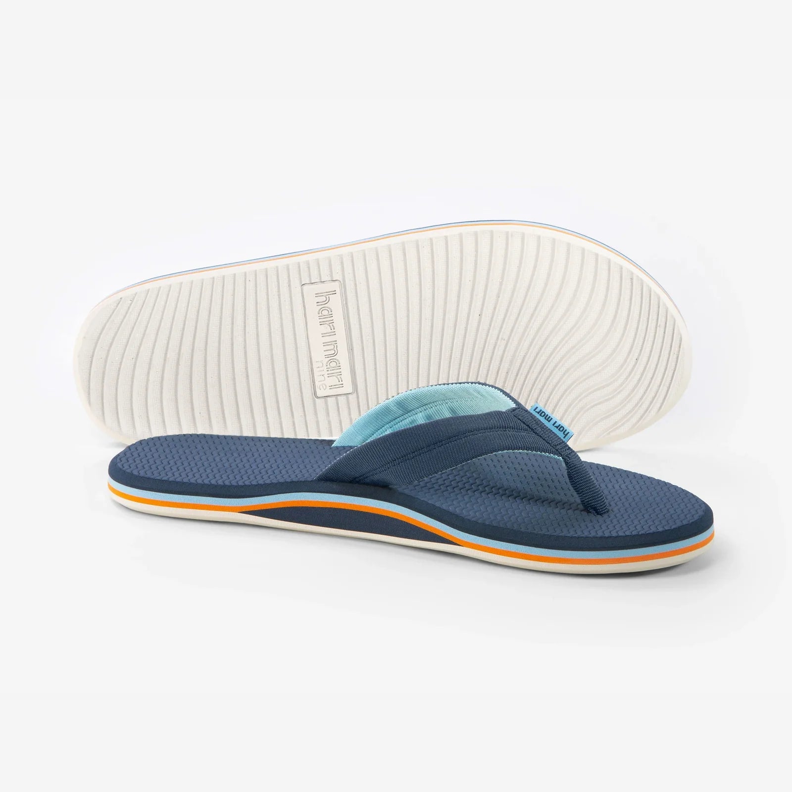Blue flip-flop sandal with a white sole on a light gray background