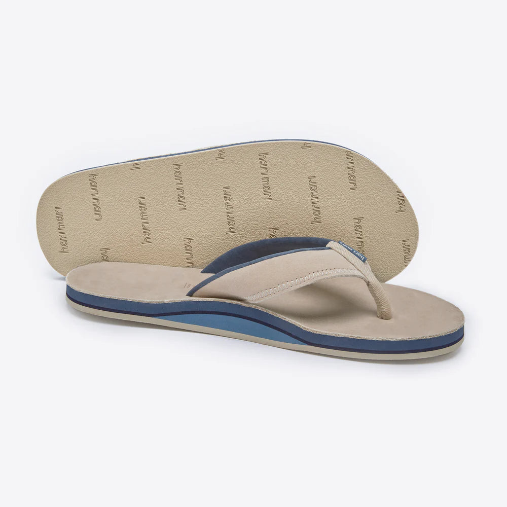 Pair of beige flip-flops with blue accents on a white background
