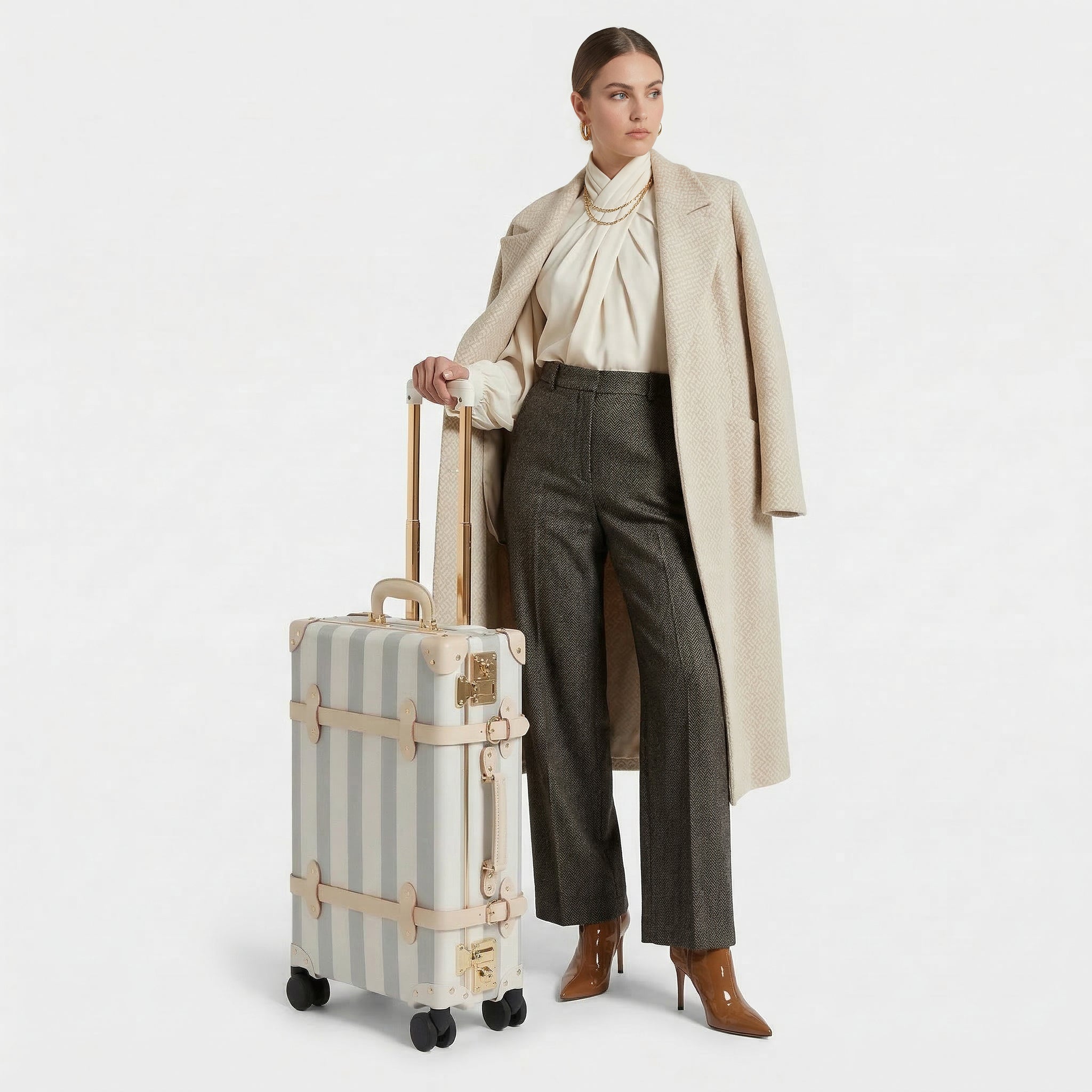 Woman holding a striped suitcase against a white background