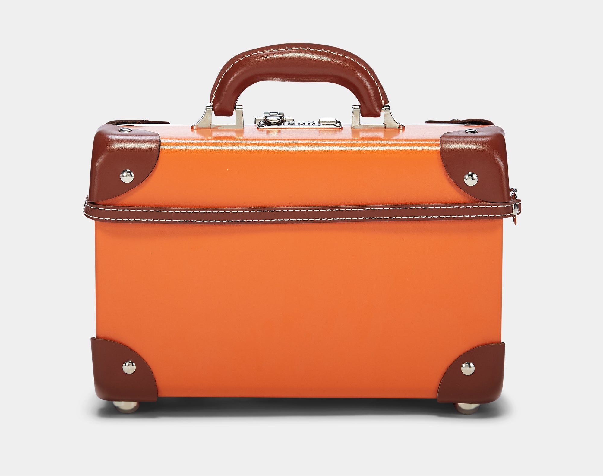 Orange suitcase with brown handles and corners on a light gray background