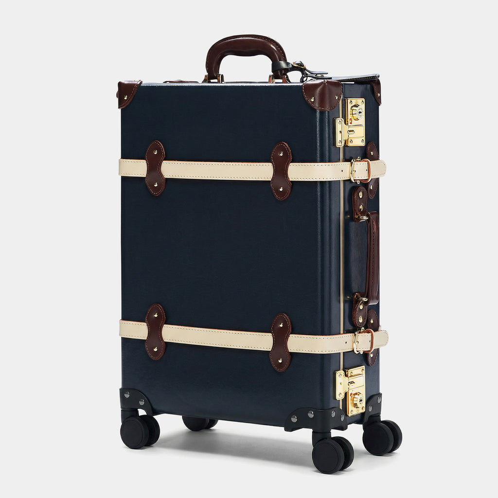 Navy suitcase with brown accents on a white background