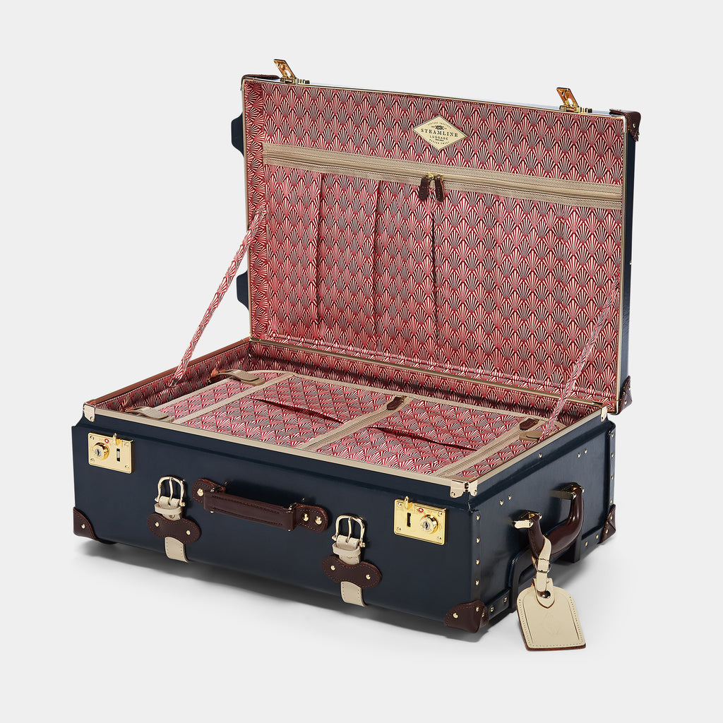 Open vintage-style suitcase with red interior and gold accents on a white background