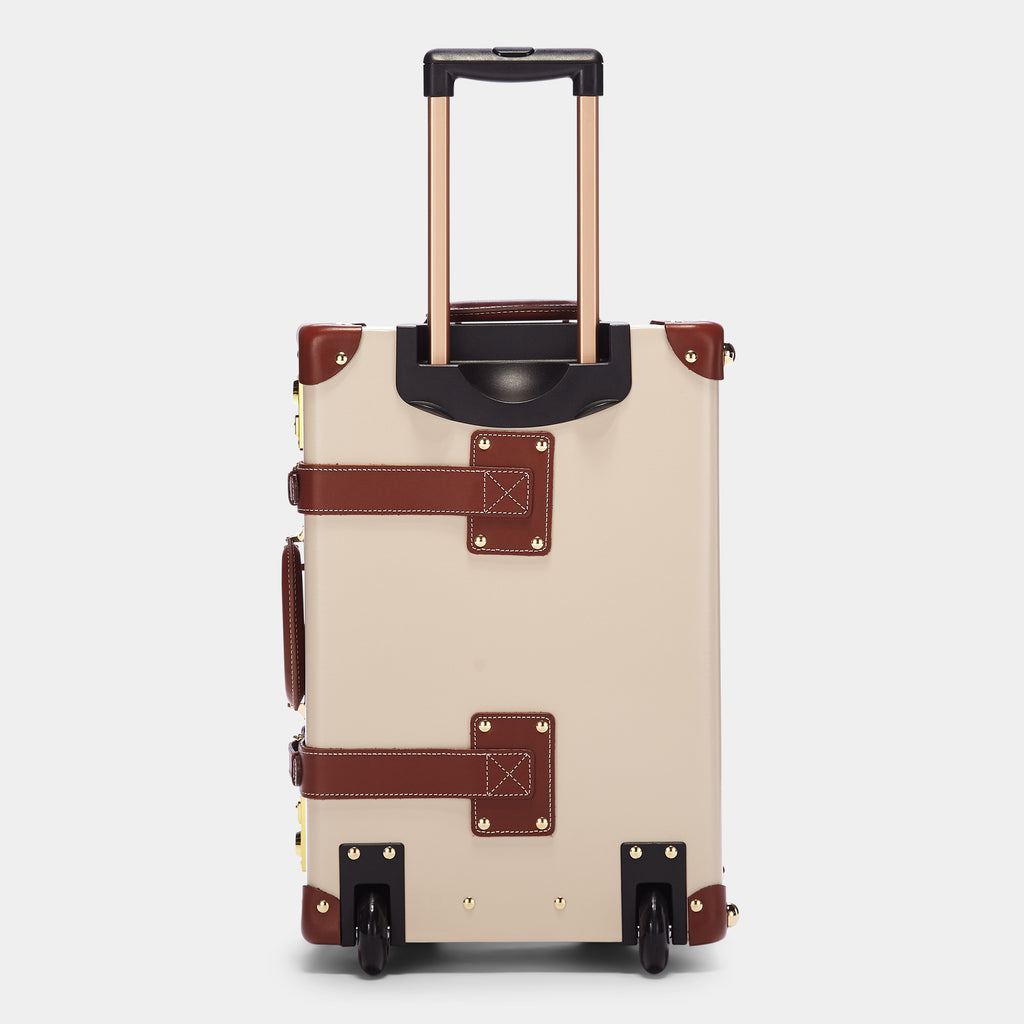 Beige suitcase with brown leather accents on a light gray background