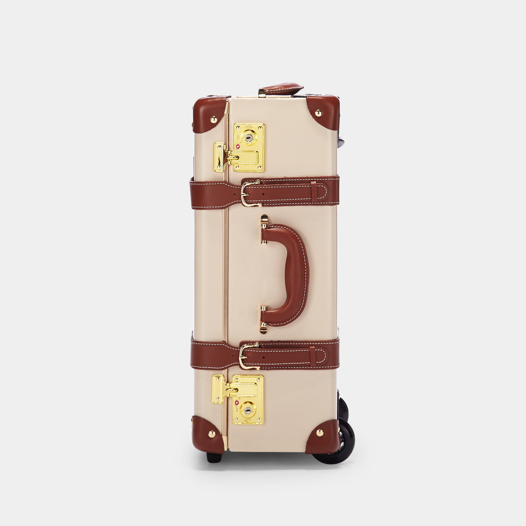 Vintage-style suitcase with beige body and brown accents on a white background