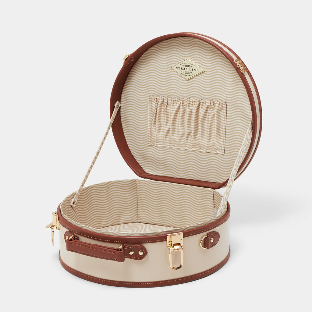 Open beige and brown hat box with a visible brand logo on a white background
