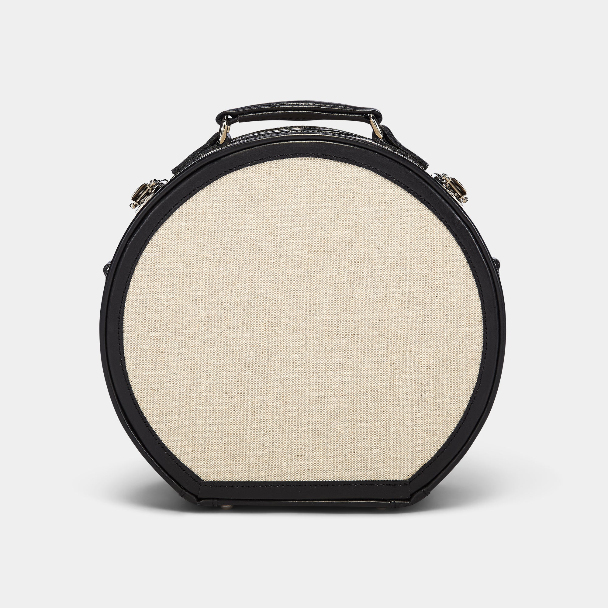 Round beige fabric case with black leather trim on a white background