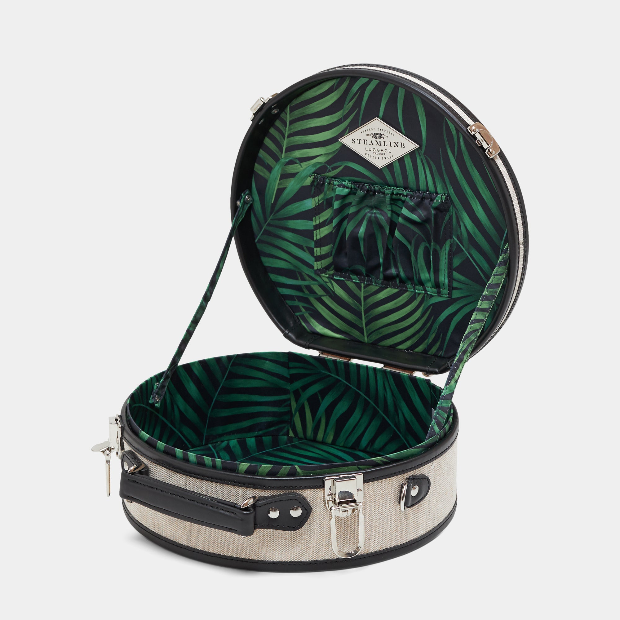 Open suitcase with green leaf pattern on a white background