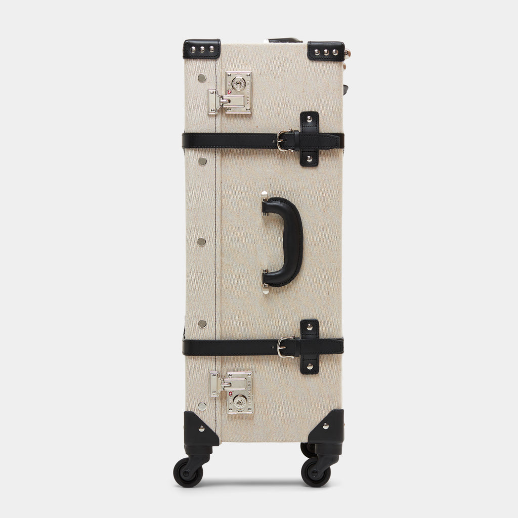 Beige suitcase with black accents on a white background