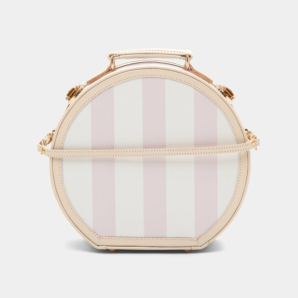 Round handbag with pink and white striped pattern on a light gray background