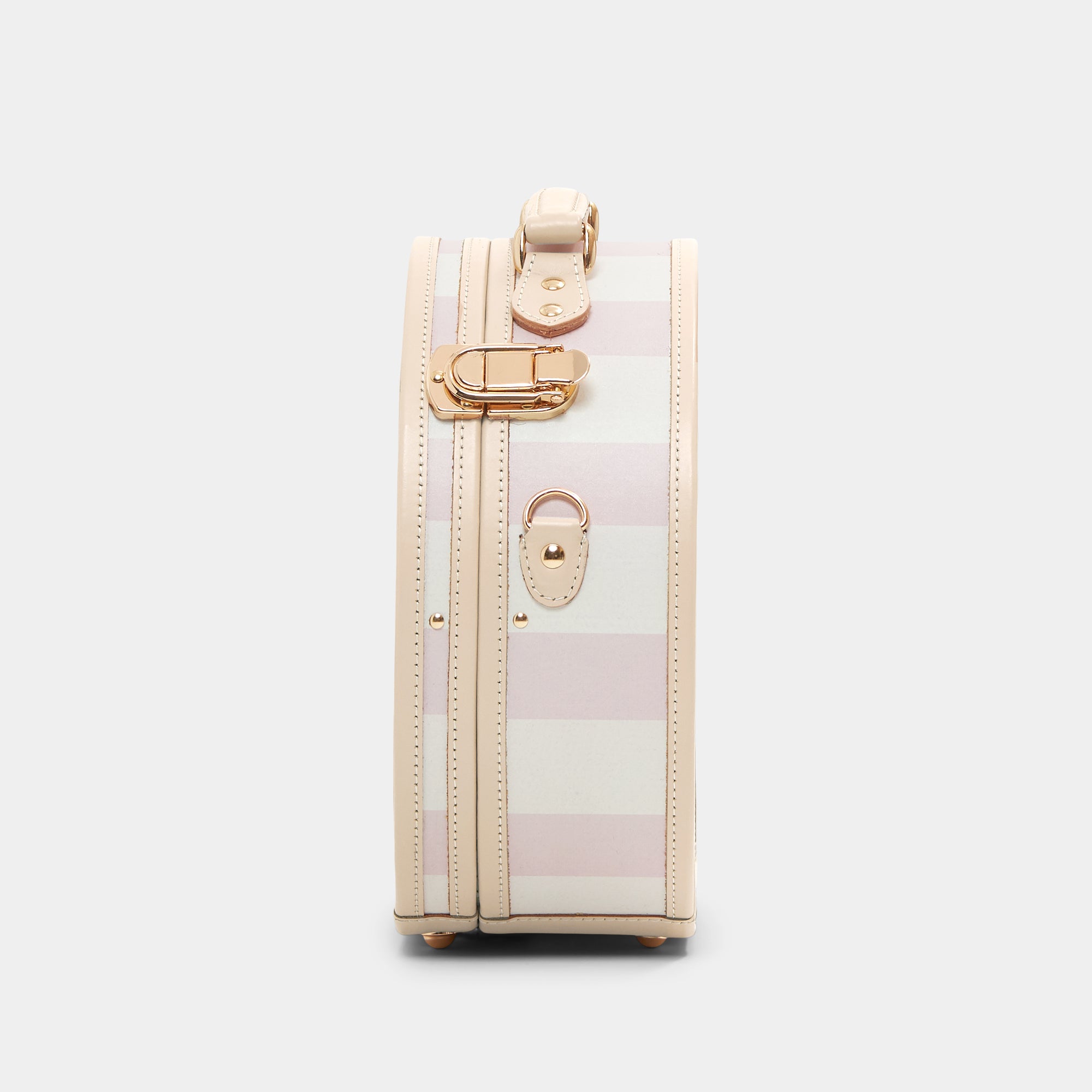Small suitcase with gold accents on a light gray background