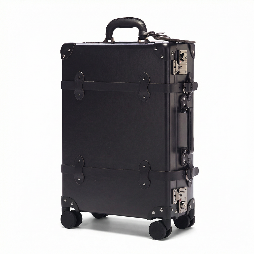 Black suitcase with metallic accents on a white background