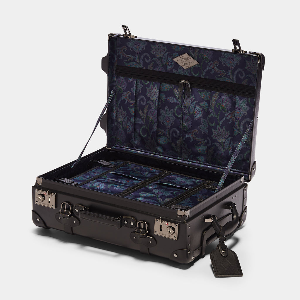 Black suitcase with floral interior on a white background