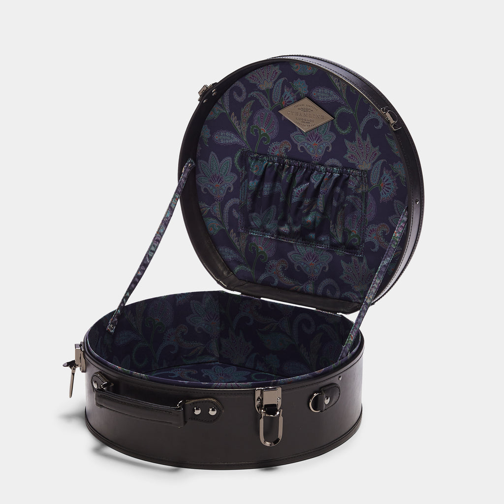 Round black suitcase with floral interior on a white background