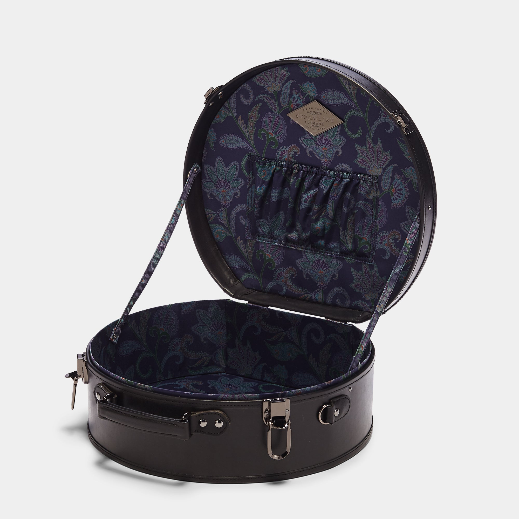 Round black suitcase with floral interior on a white background