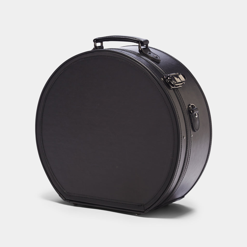 Black suitcase on a light gray background