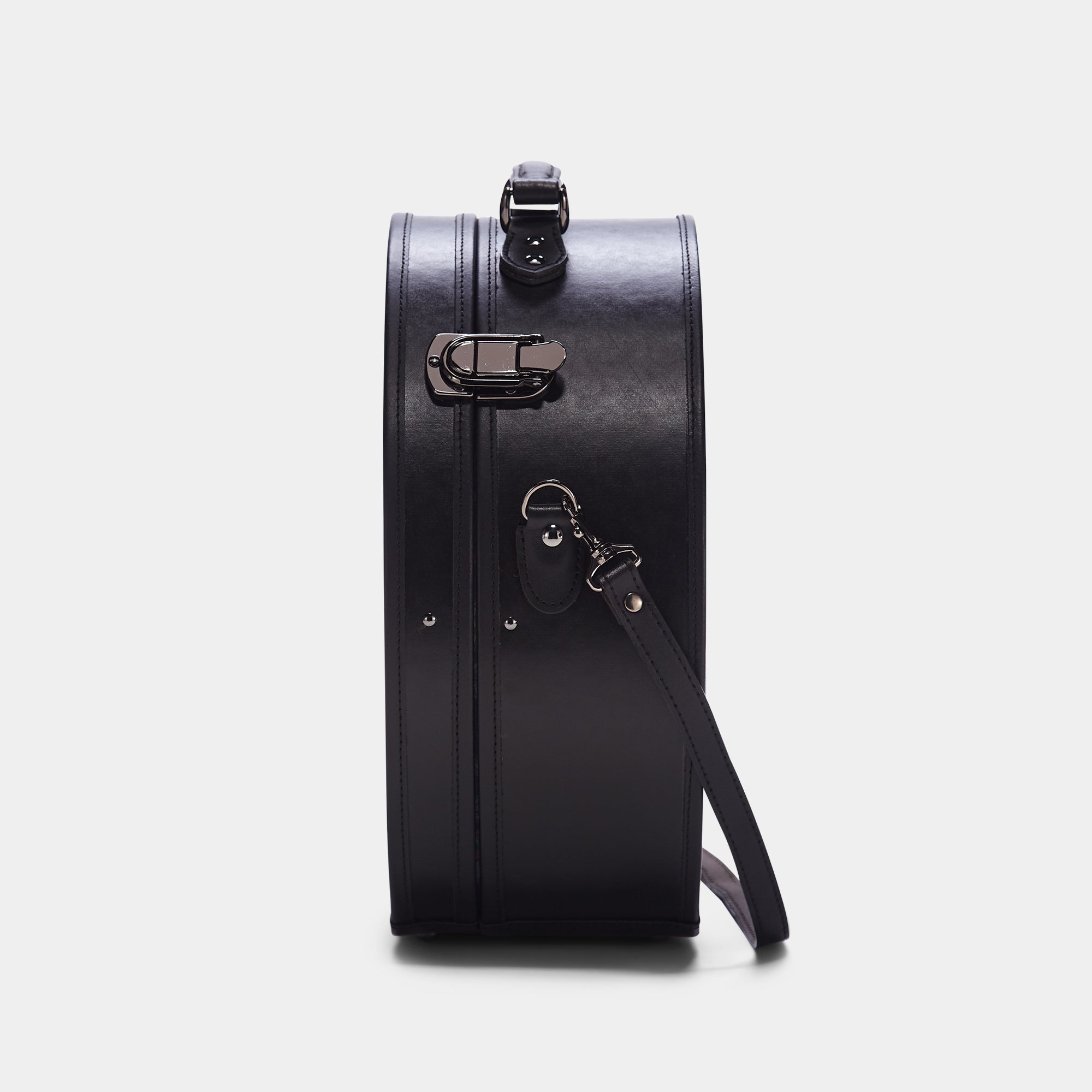 Black leather suitcase with a strap on a white background