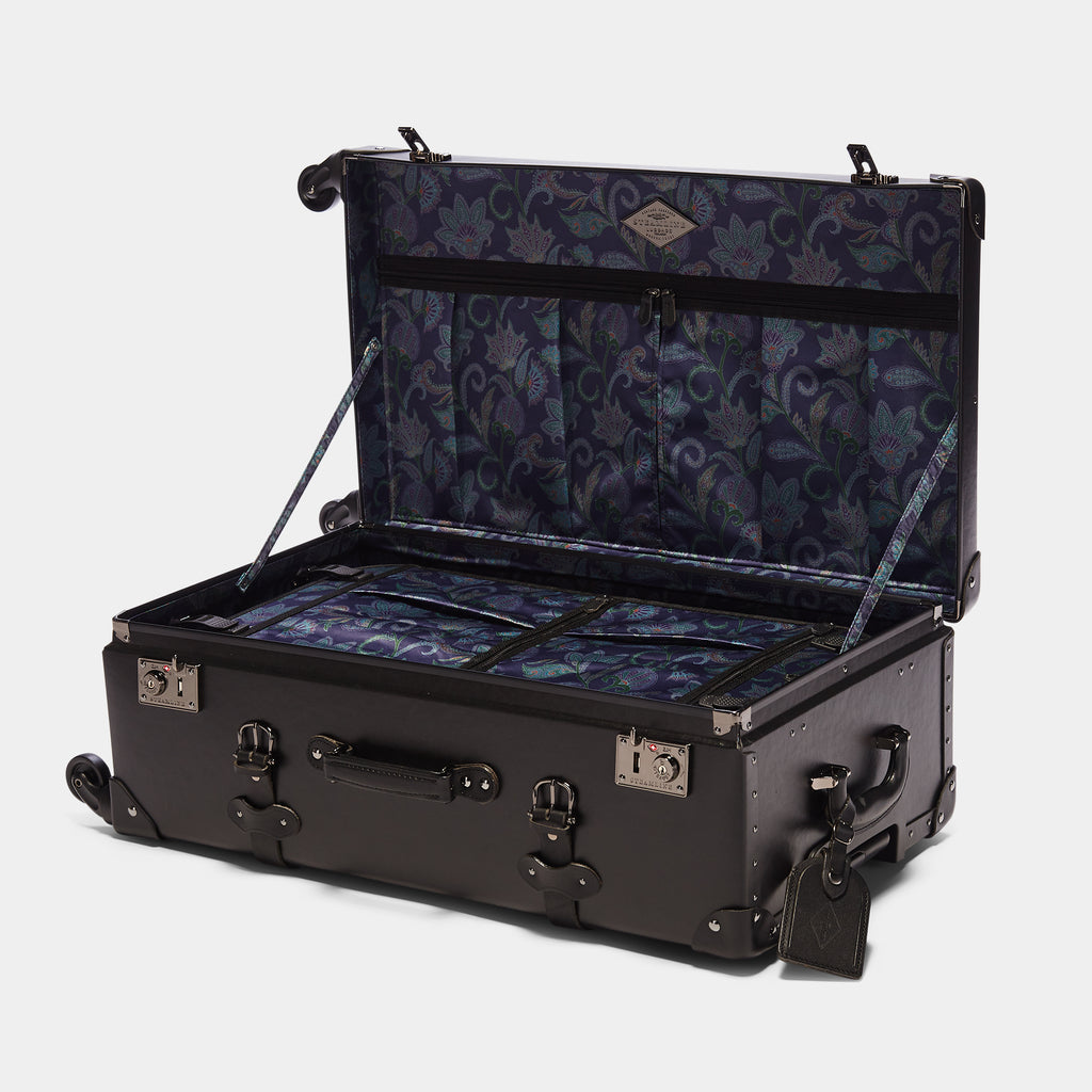 Open black suitcase with floral interior on a white background