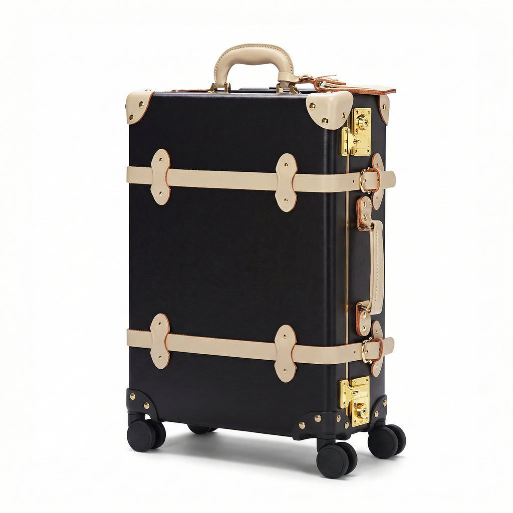 Black suitcase with gold accents on a white background