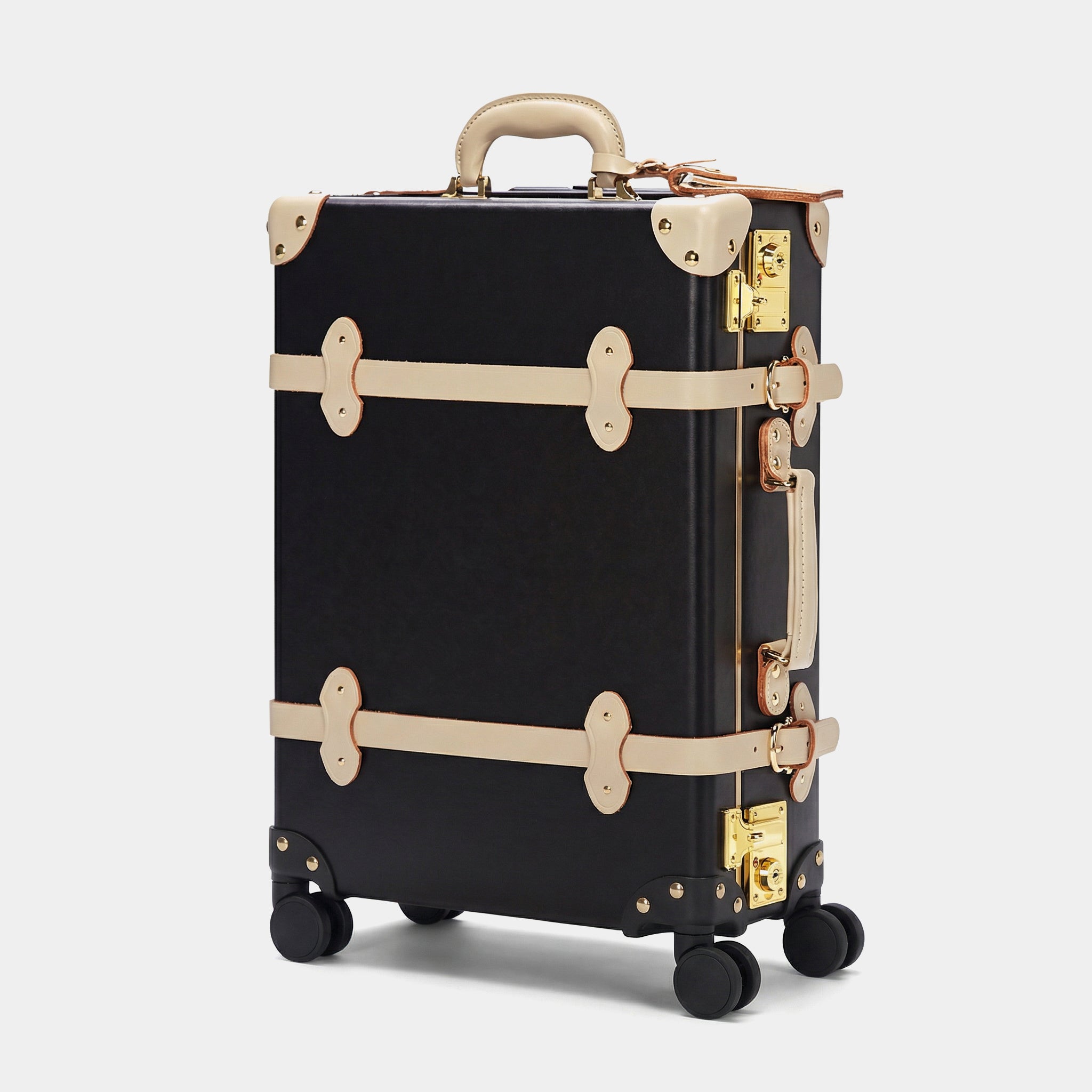 Black suitcase with gold accents on a white background