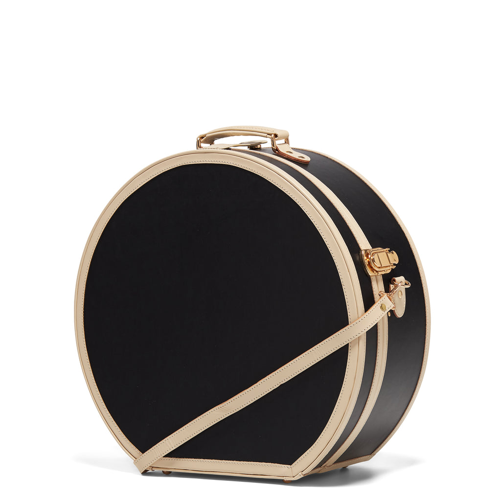 Black round box with gold trim on a white background