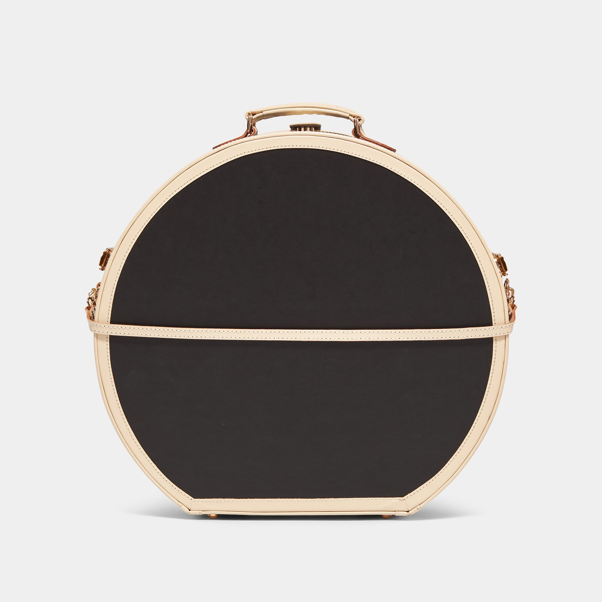 Black round hatbox with beige trim on a light gray background