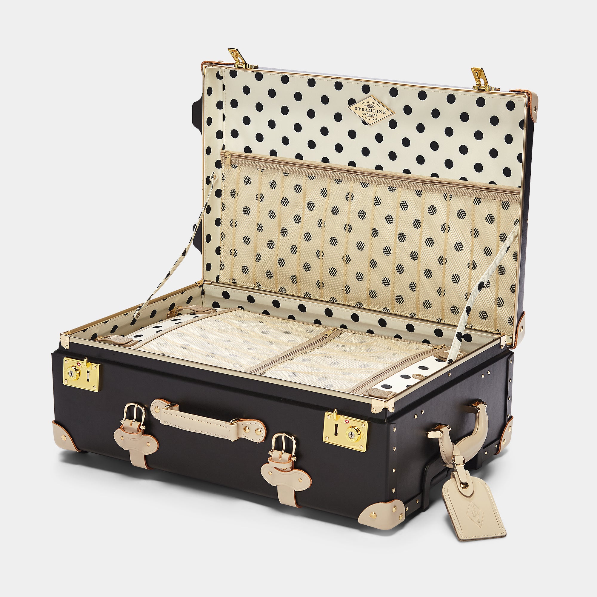 Open suitcase with polka dot interior on a white background