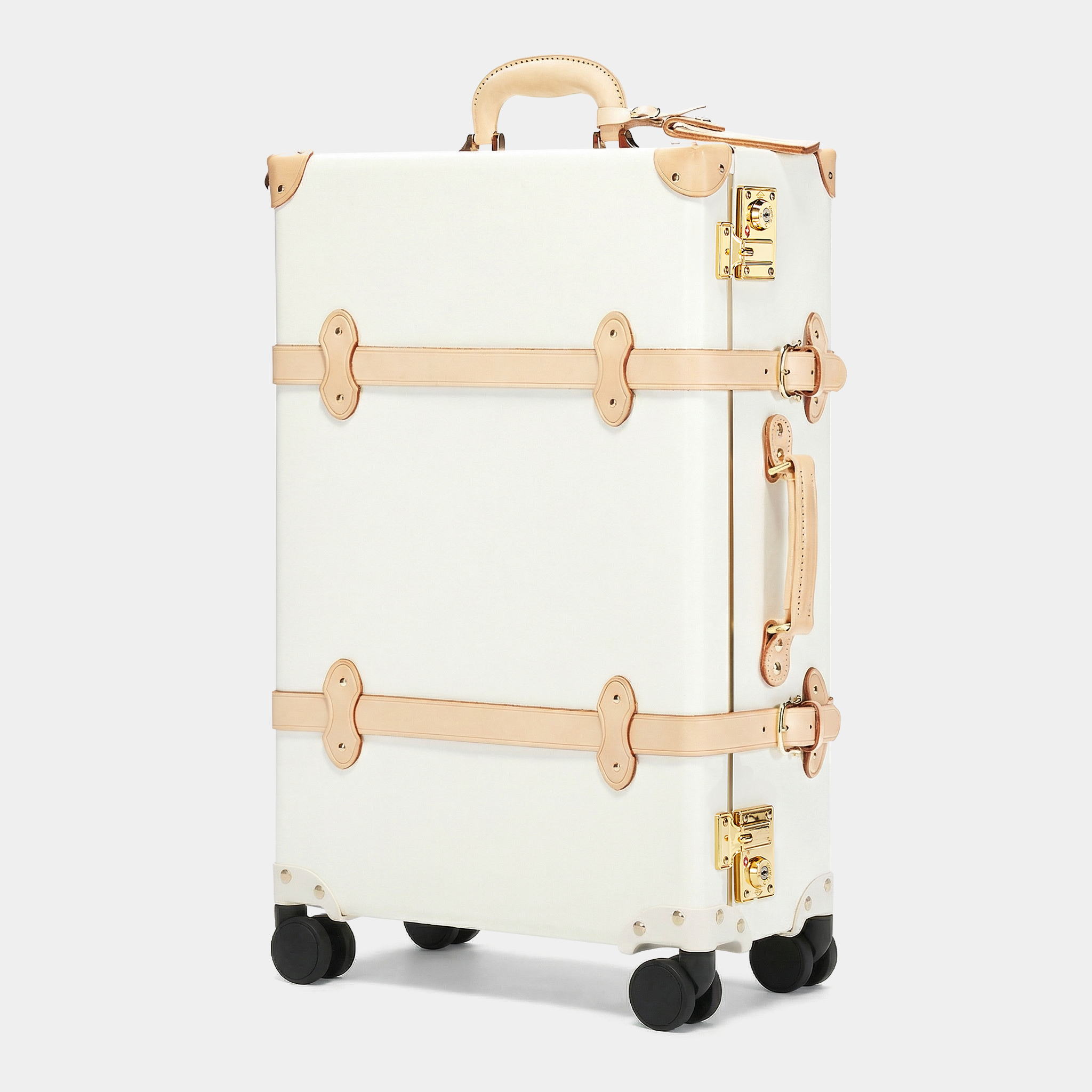 White suitcase with gold accents on a light gray background
