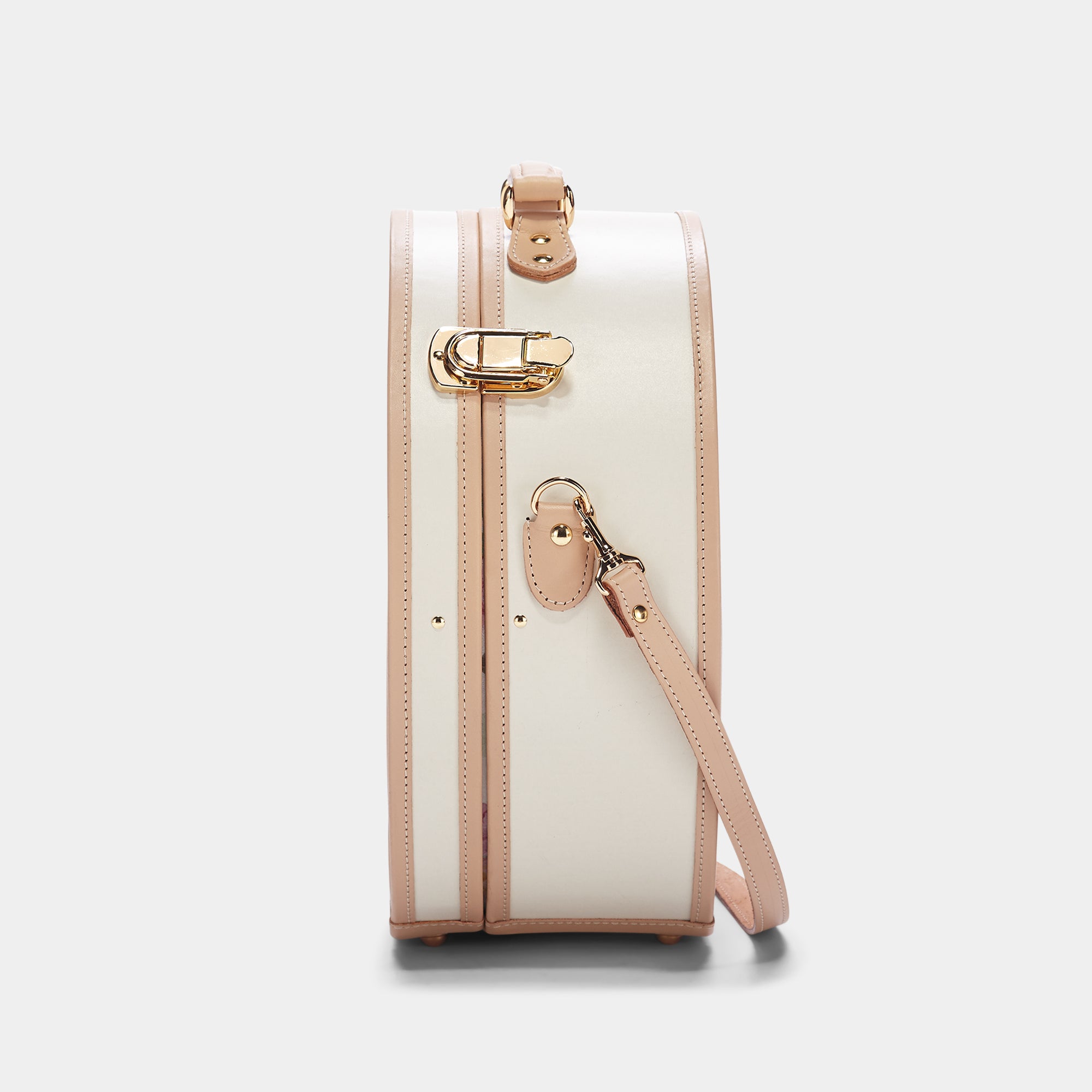 White handbag with beige accents on a light gray background