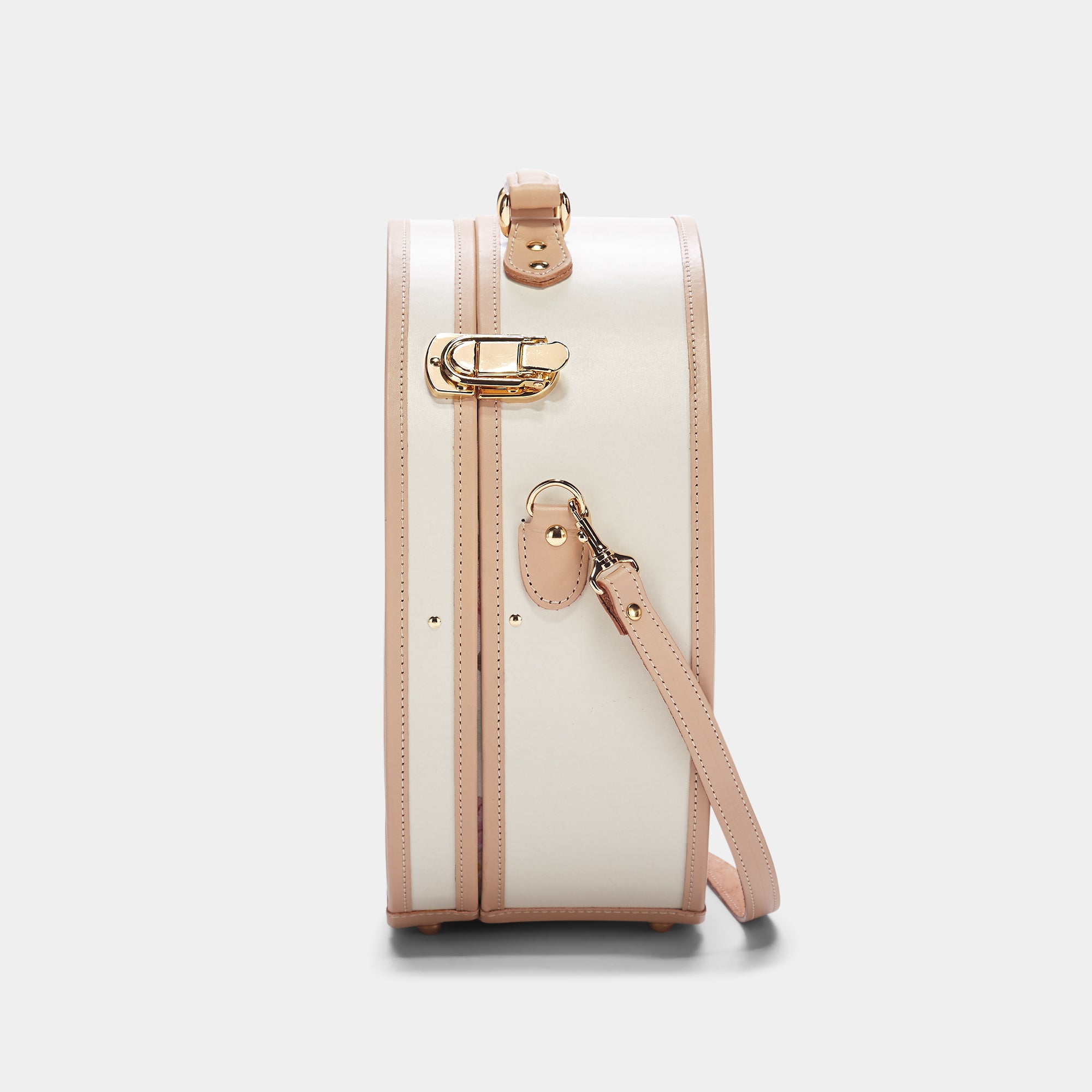 White handbag with pink accents on a light gray background
