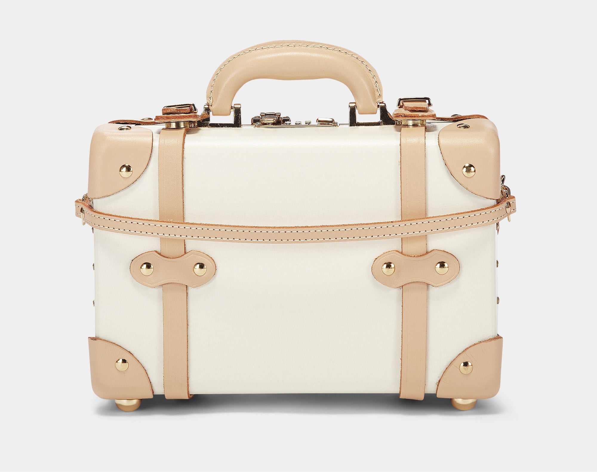 Small white suitcase with gold accents on a light gray background