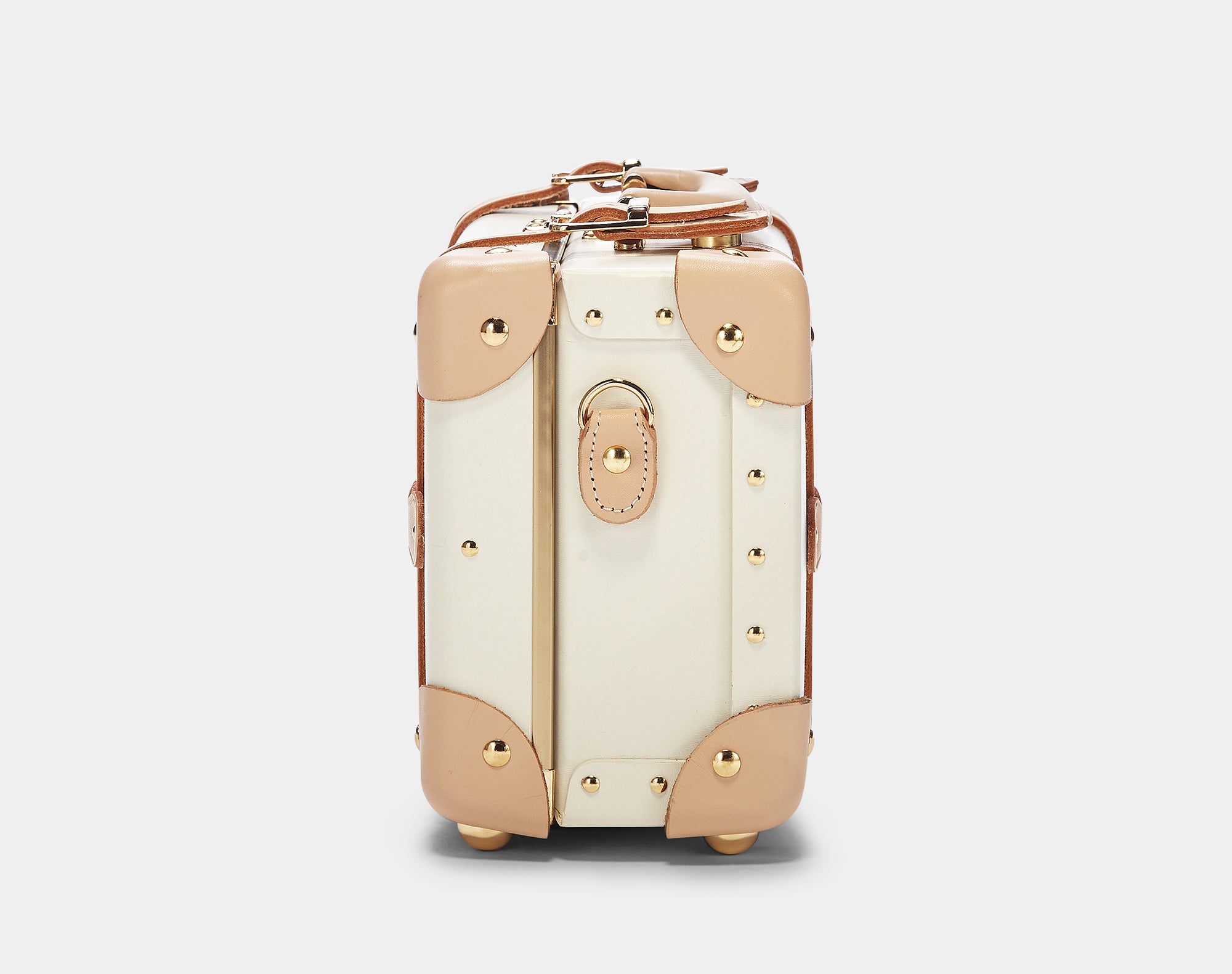 Cream-colored suitcase with gold accents on a light gray background
