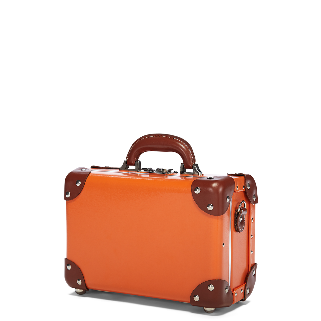 Orange suitcase with brown accents on a white background