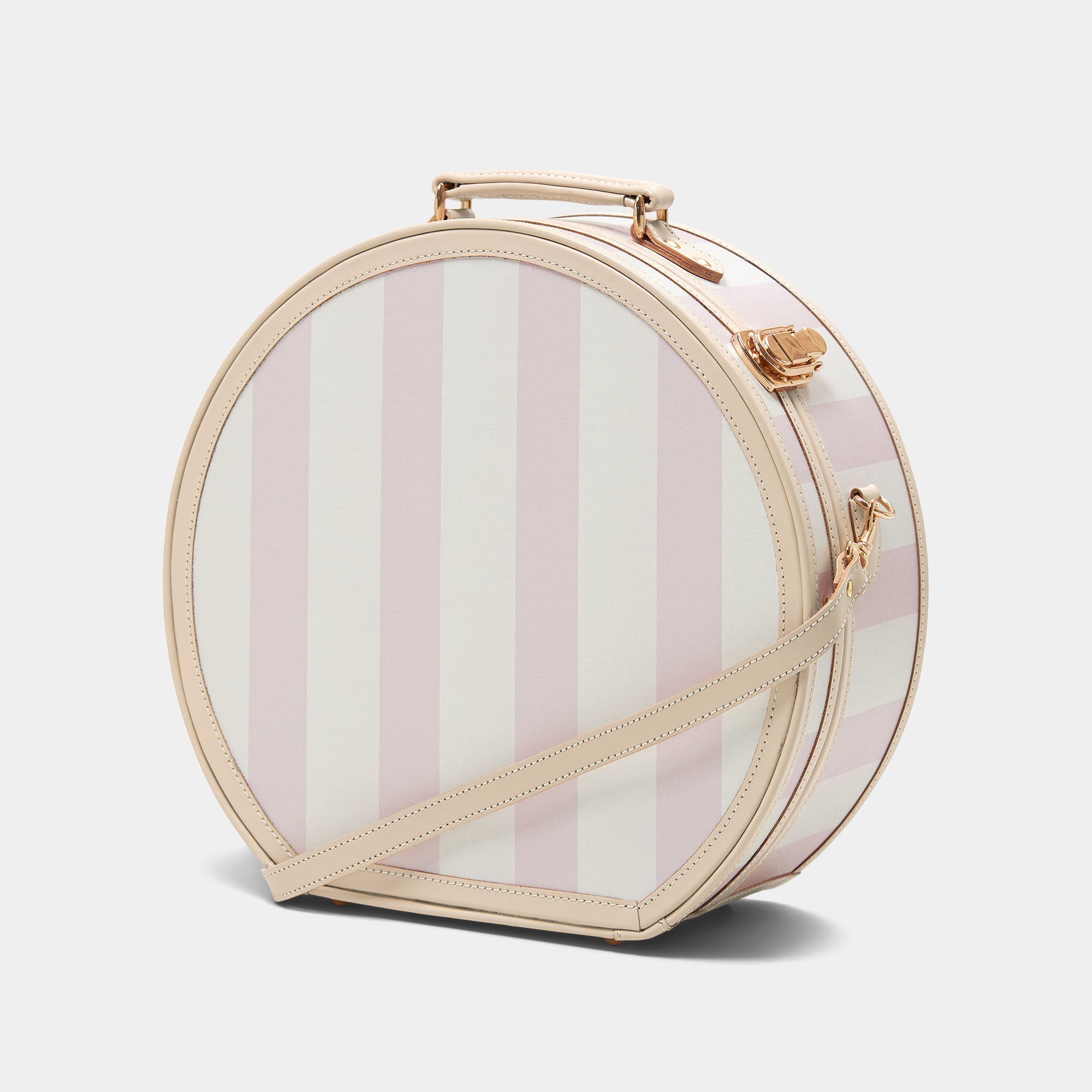 Round striped handbag with a gold handle and strap on a light gray background