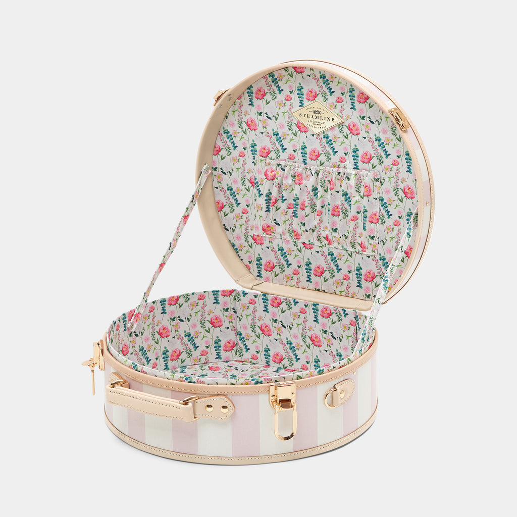 Round floral-patterned suitcase with open lid on a white background