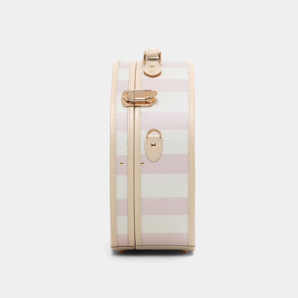 Pink and white striped suitcase with gold accents on a light gray background