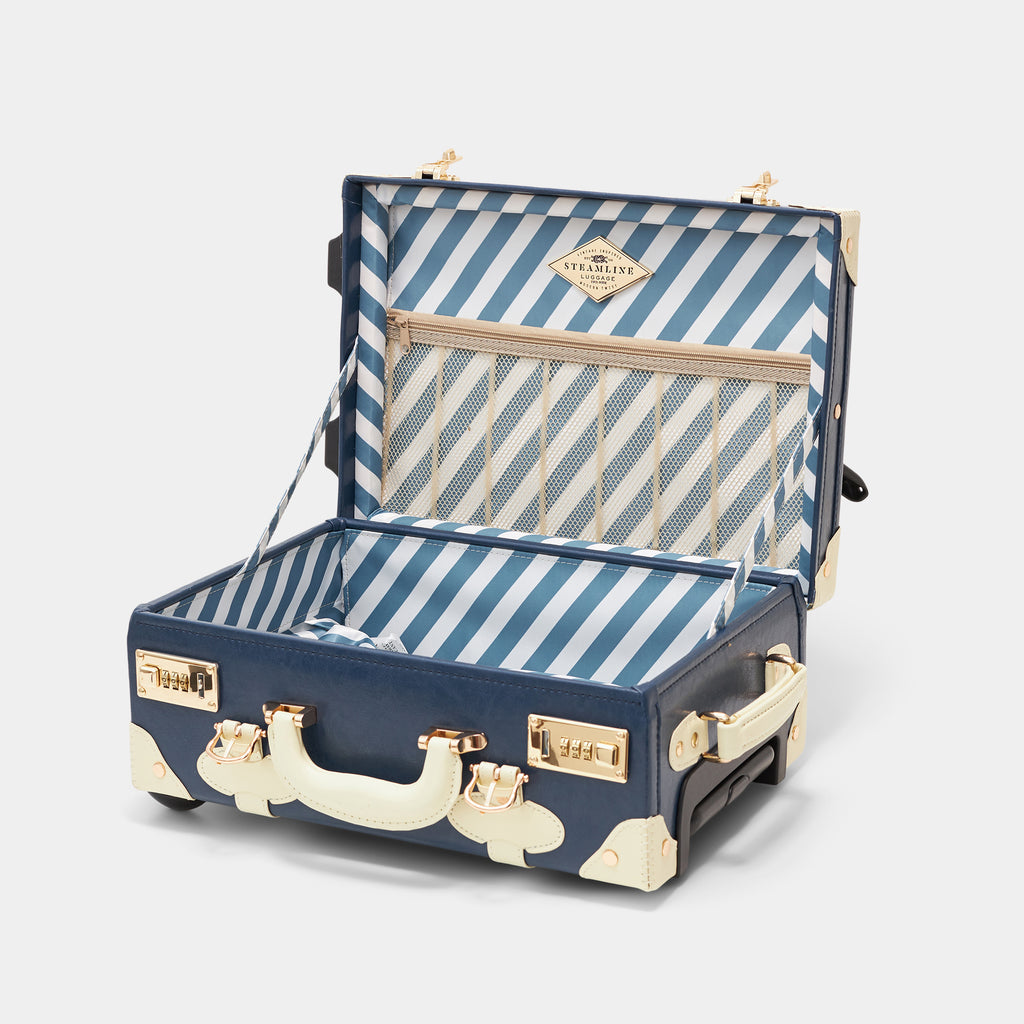 Navy and white striped suitcase with gold accents on a light gray background