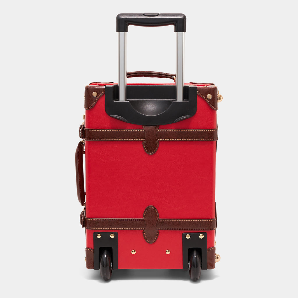 Red suitcase with brown accents on a light gray background